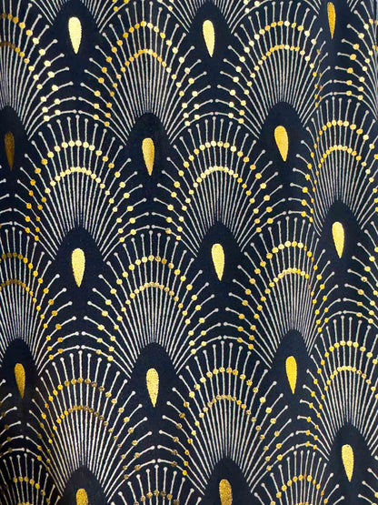 Detail of the gold-toned fan print on black silk-blend fabric